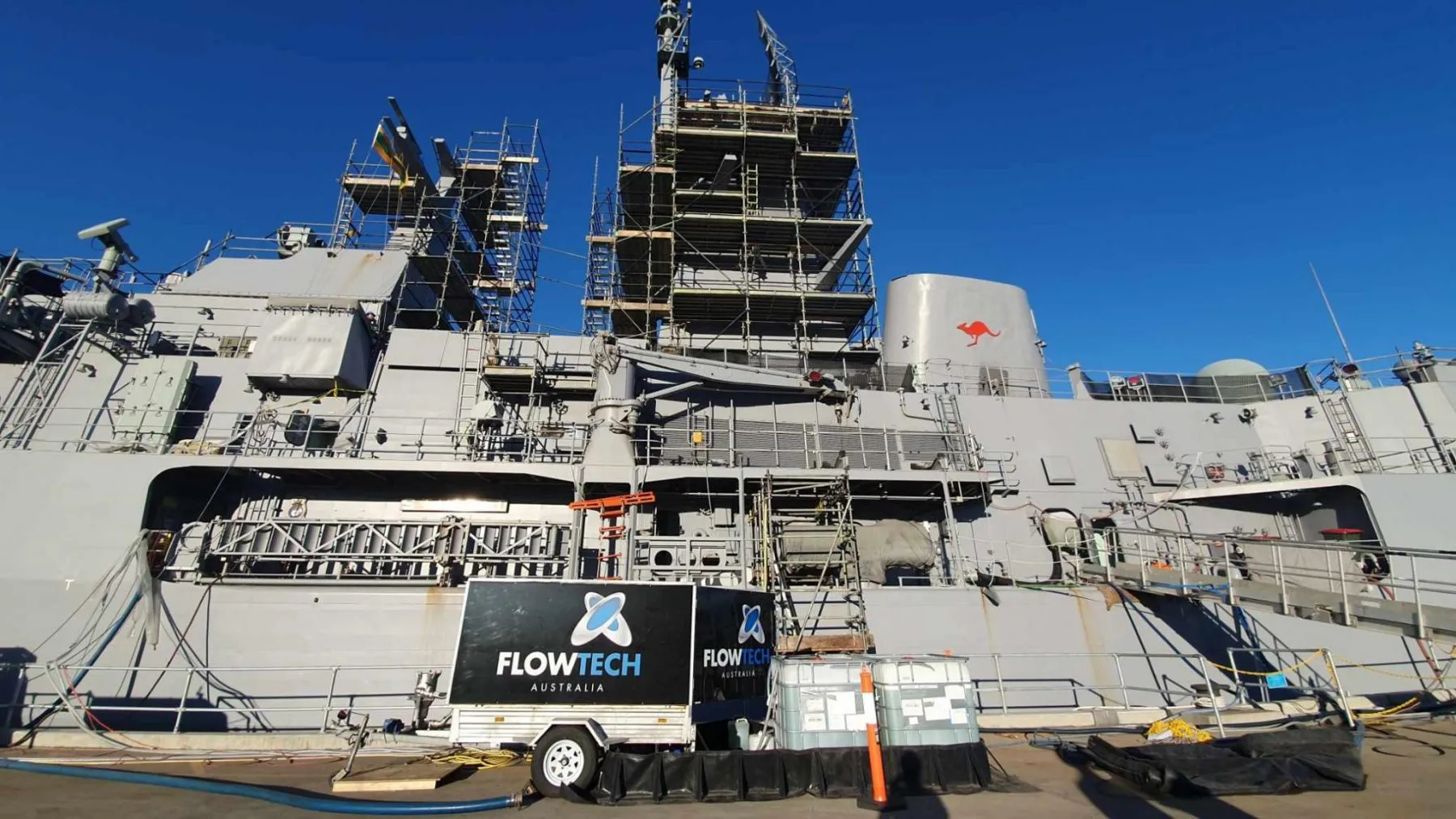 Flowtech trailer besides Australian Naval Vessel at port